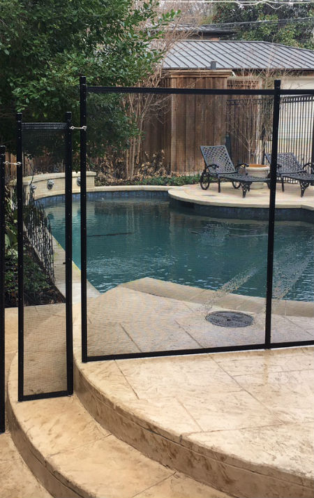 Black pool fence blocking off a patio in the Park Cities