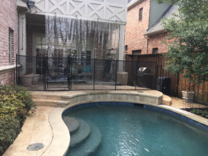 Blocking off the patio of this park cities home with a black pool safety fence.