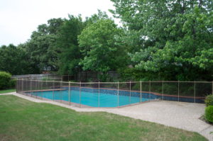 Bronze mesh with tan border and poles coppell